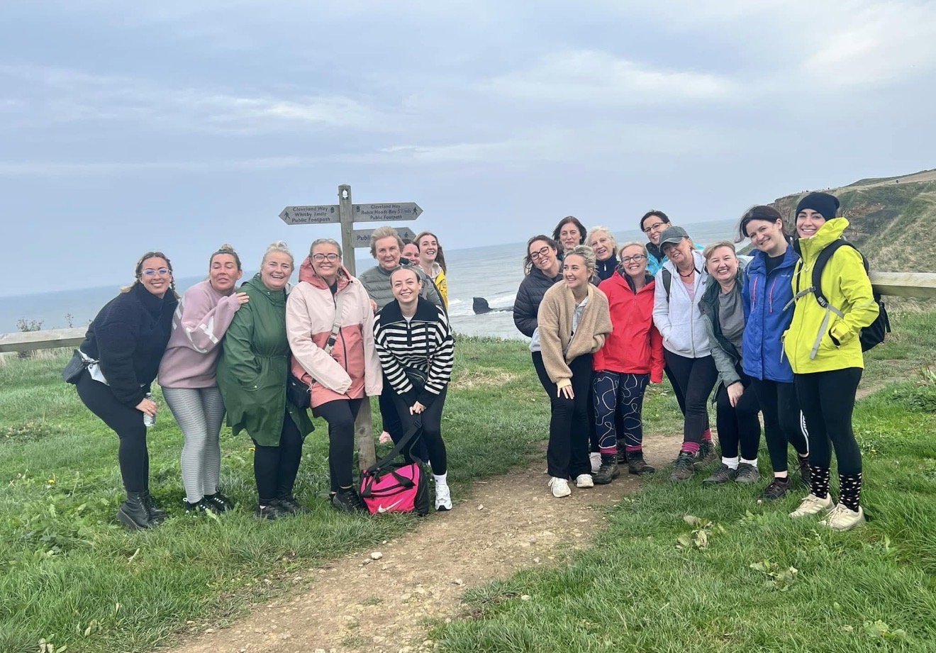Friends walking a coastal cliff path together